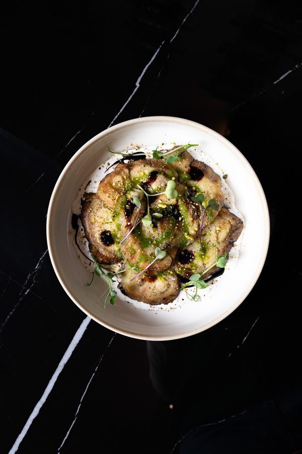 A beautifully plated dish on our marble table